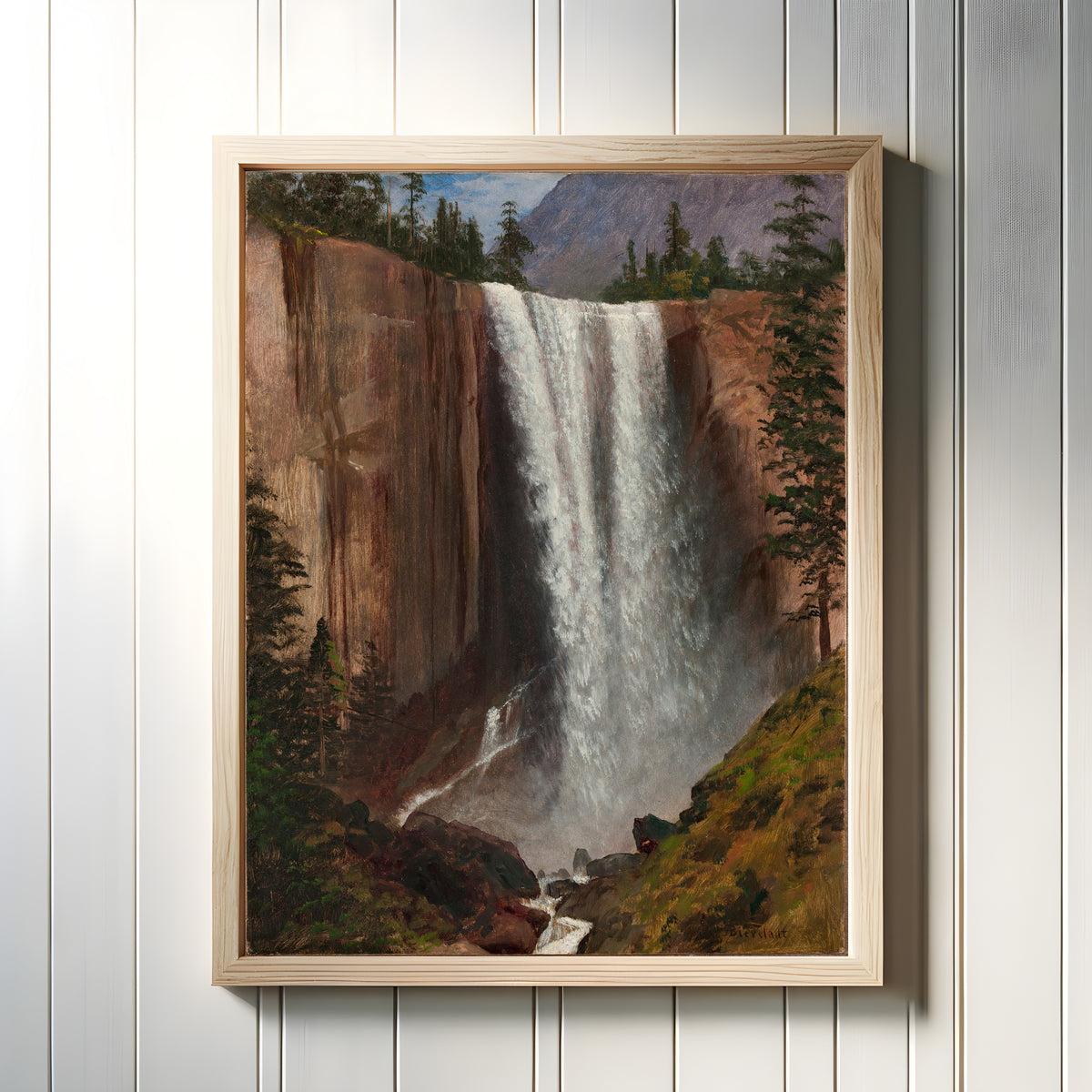 Framed art print of Vernal Fall by Albert Bierstadt, in a light wood frame on a white panelled wall