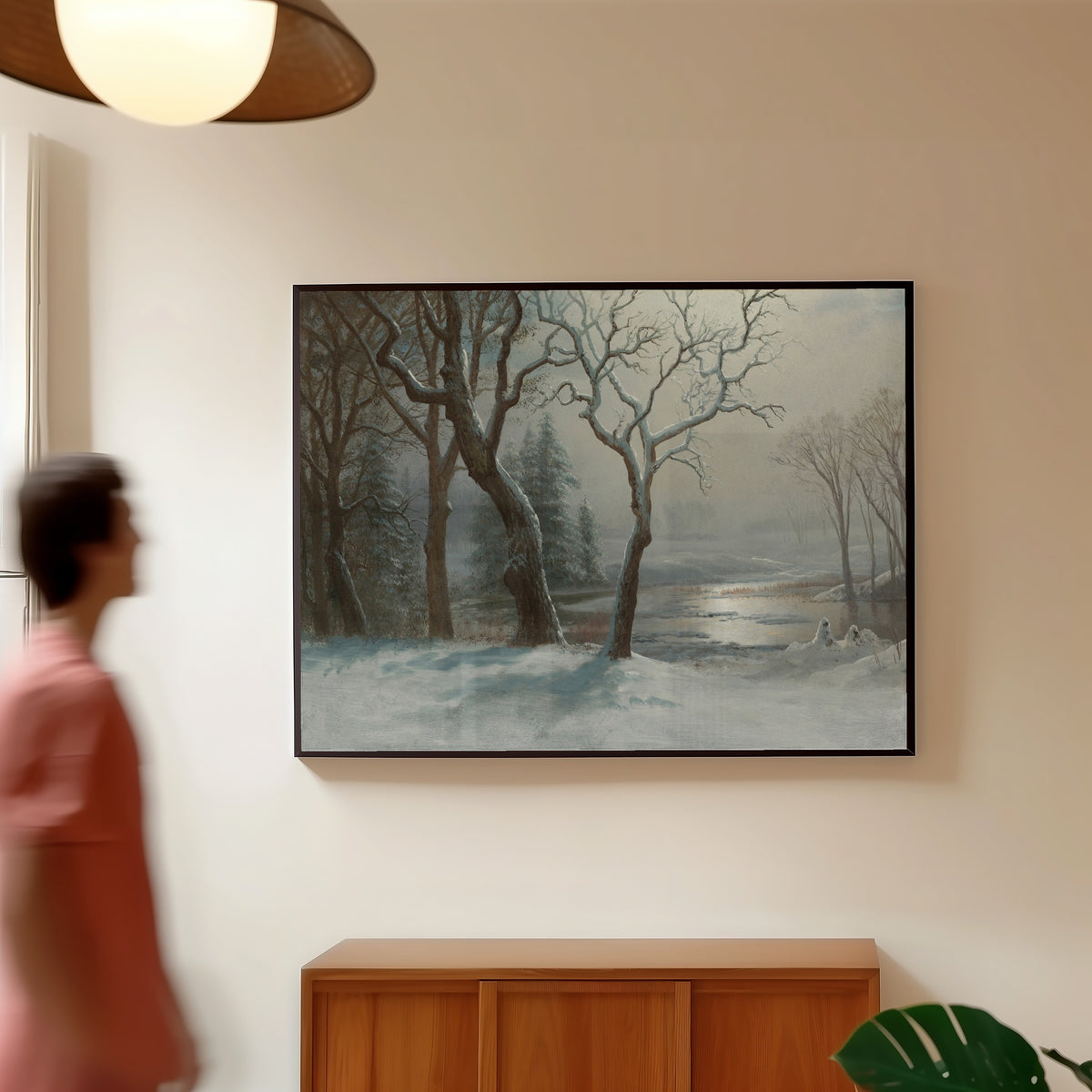Framed art print of Winter in Yosemite by Albert Bierstadt, in a slim black frame on a warm wall in a sunlit room