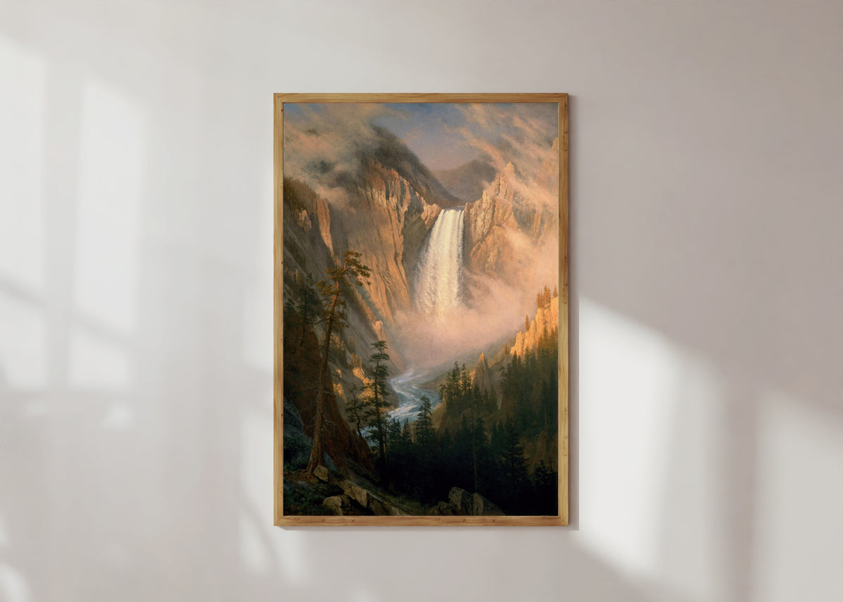 Framed art print of Yellowstone Falls by Albert Bierstadt, in a light wood frame on a sunlit white wall