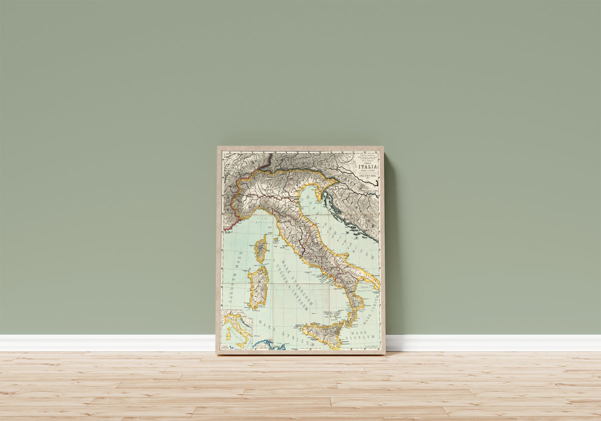 Framed art print of Italia (Tabulae Maximae) by Albert van Kampen, in a light wood frame leaning on a sage green wall above a wooden floor