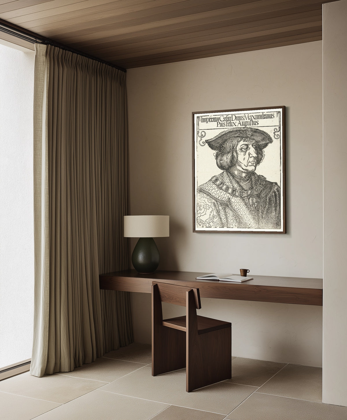 Framed art print of Emperor Maximilian I by Albrecht Dürer, in a dark wood frame on a plaster wall above a walnut desk