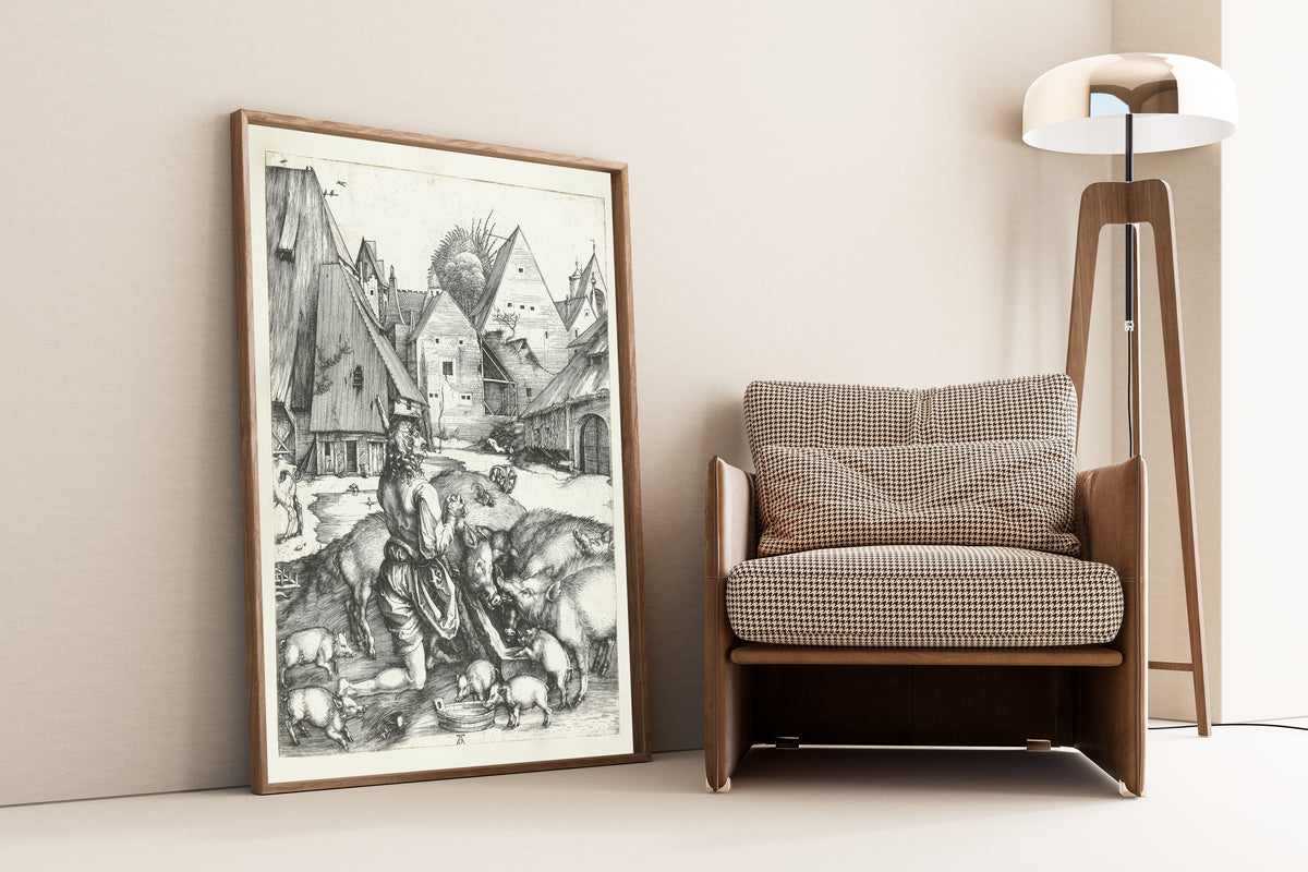 Framed art print of The Prodigal Son Amid the Swine by Albrecht Dürer, leaning against a wall beside an armchair and a floor lamp