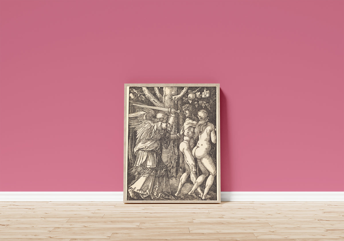 Framed art print of The Small Passion: The Expulsion from Paradise by Albrecht Dürer, in a light wood frame leaning on a pink wall above a wooden floor