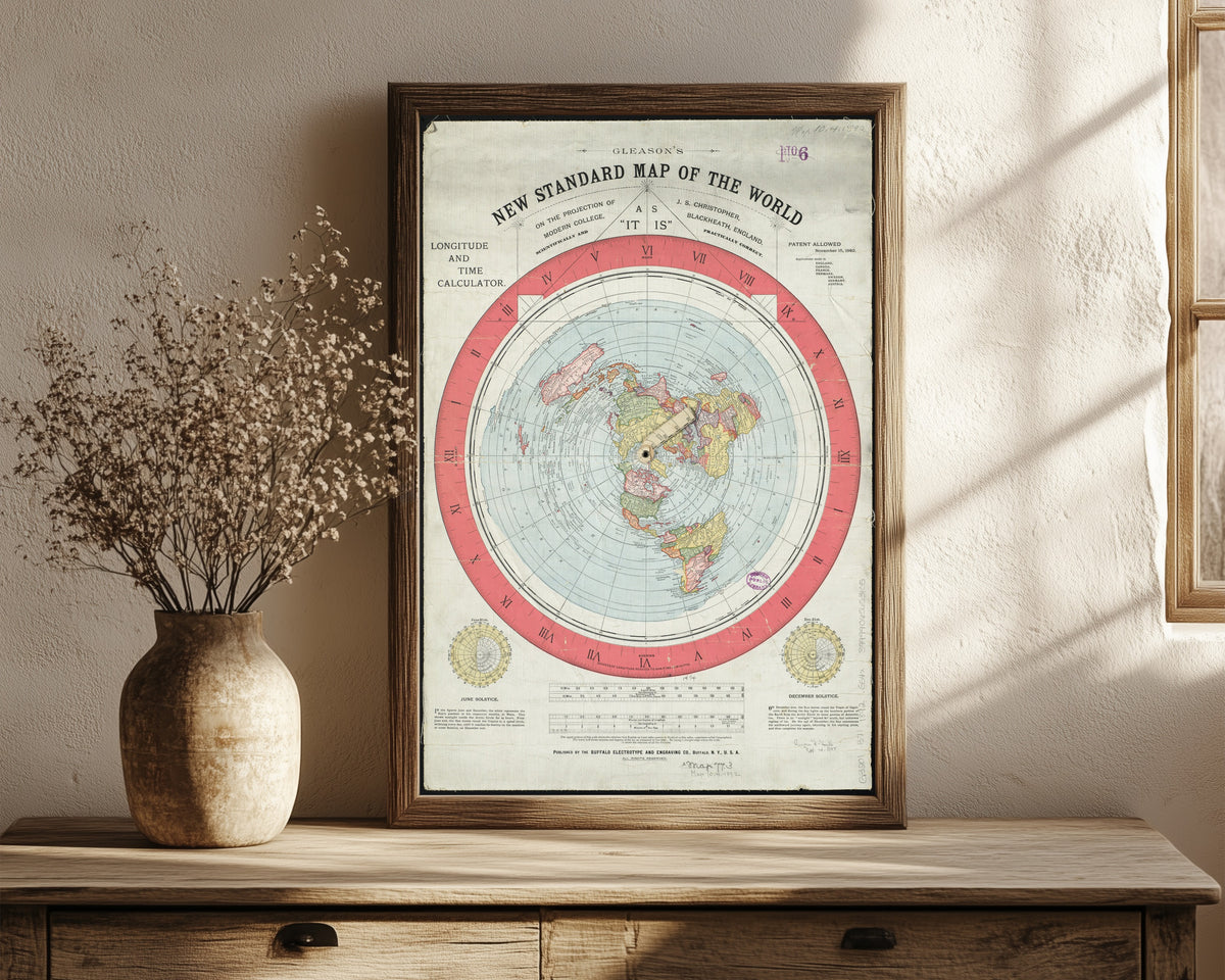 Framed art print of Gleason's New Standard Map of the World by Alexander Gleason, in a dark wood frame leaning on a rustic console beside dried flowers