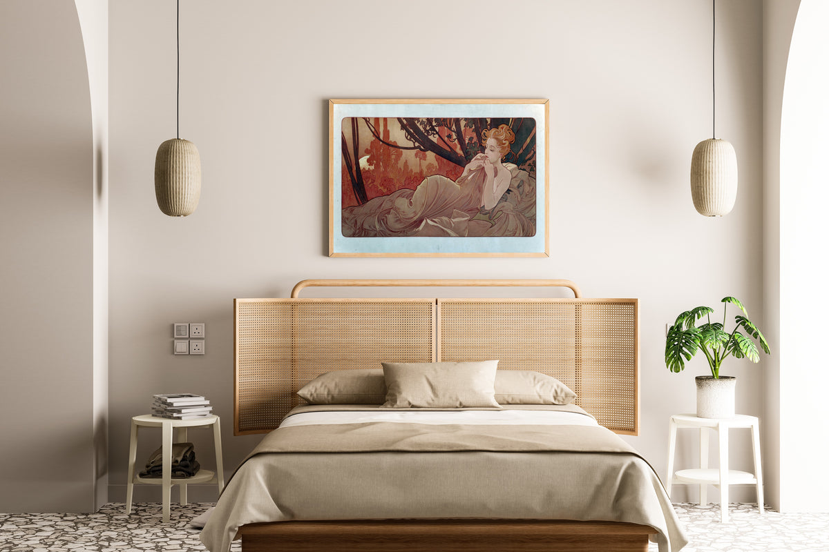 Framed art print of Dusk by Alphonse Mucha, above a cane-headboard bed