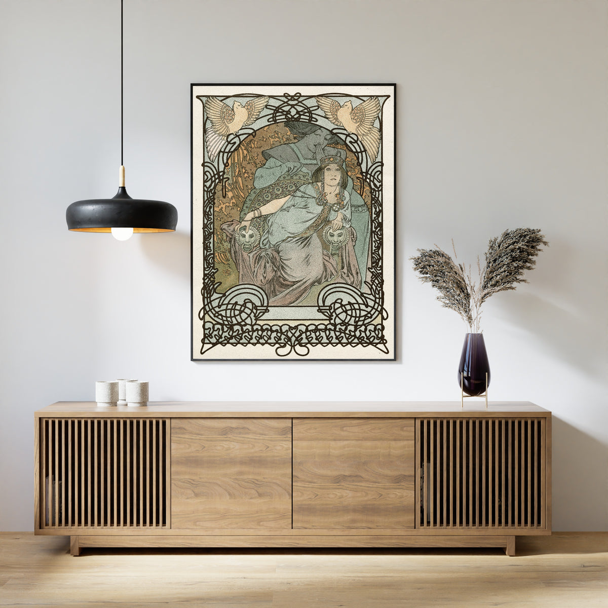 Framed art print of Ilsée, Princesse de Tripoli by Alphonse Mucha, above a slatted wood sideboard