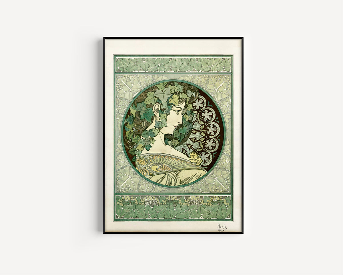 Framed art print of Ivy by Alphonse Mucha, in a slim black frame on a plain white wall