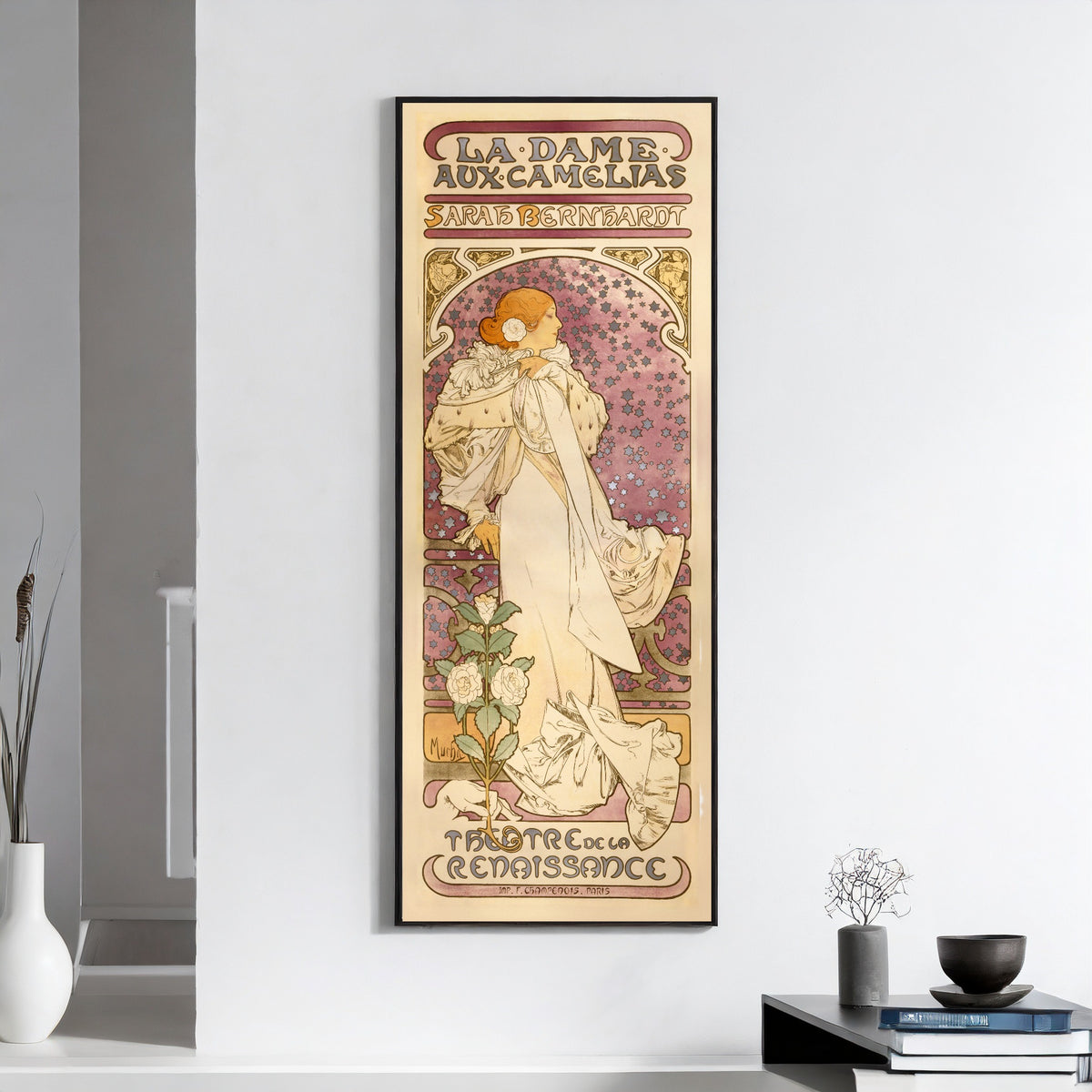 La Dame aux Camélias by Alphonse Mucha — framed on a white wall above books and a bowl
