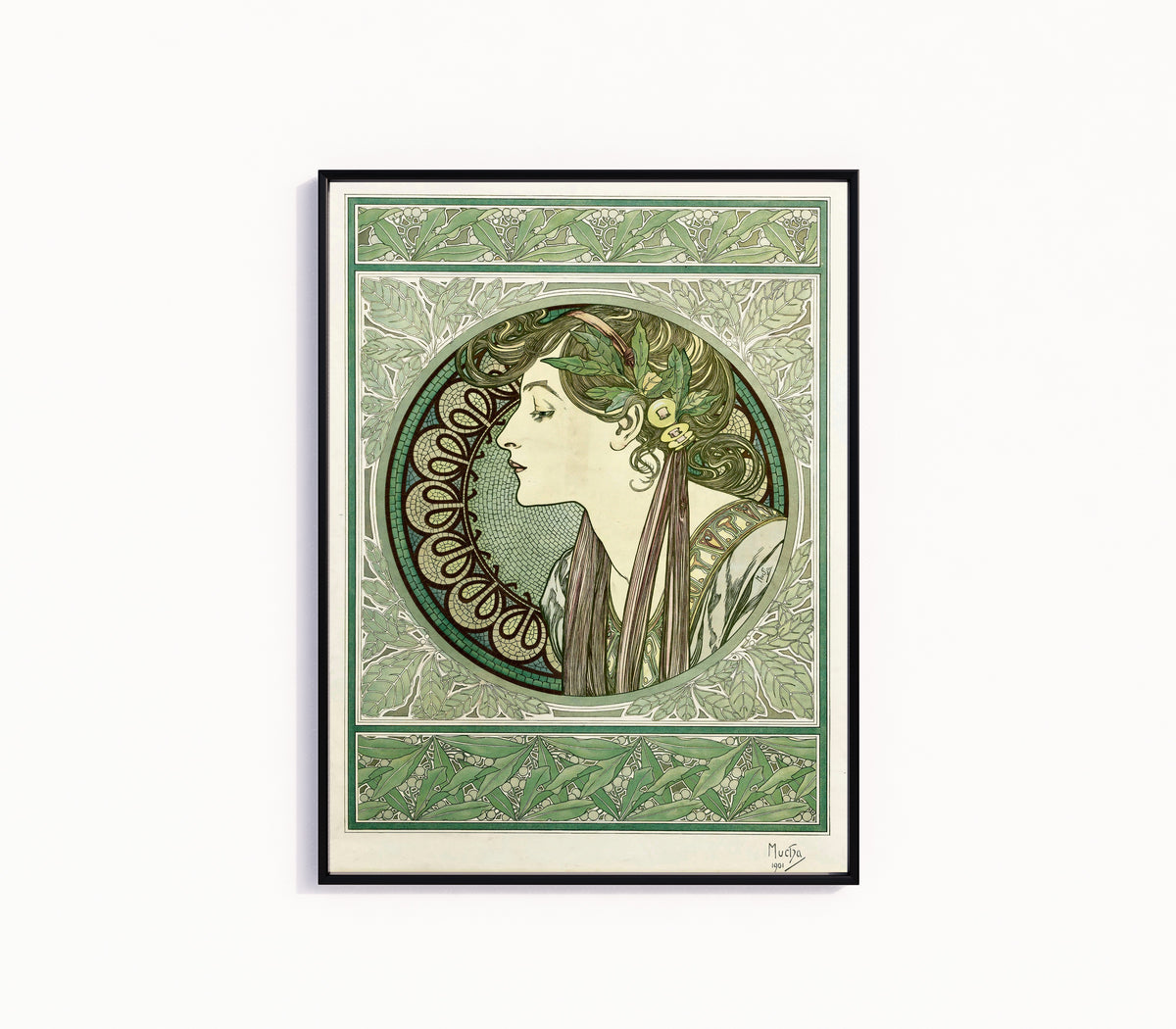 Framed art print of Laurel by Alphonse Mucha, in a slim black frame on a plain white wall