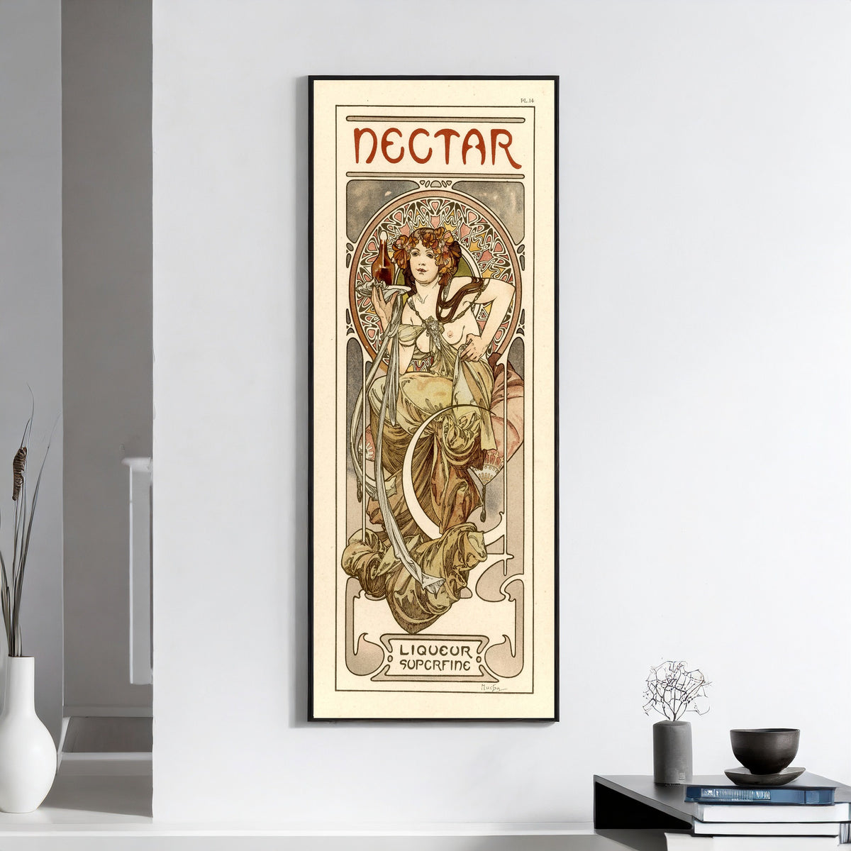 Framed art print of Nectar by Alphonse Mucha, on a white wall above books and a bowl