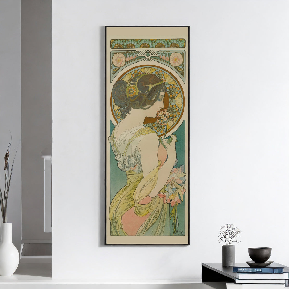 Primrose by Alphonse Mucha — framed on a white wall above books and a bowl