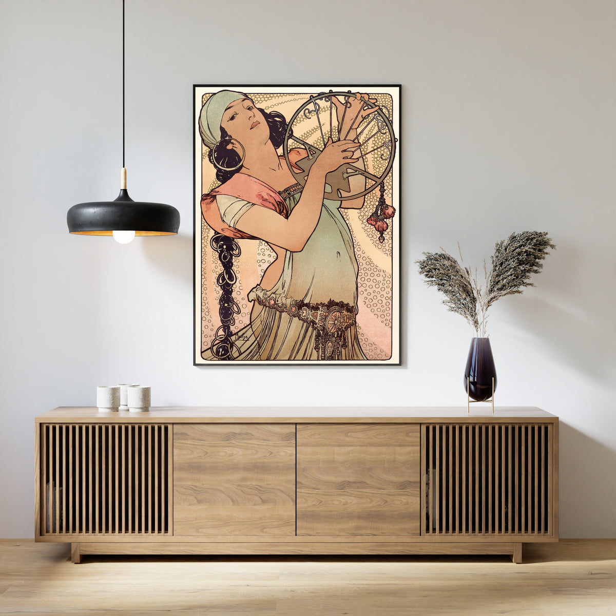 Framed art print of Salomé by Alphonse Mucha, above a slatted wood sideboard