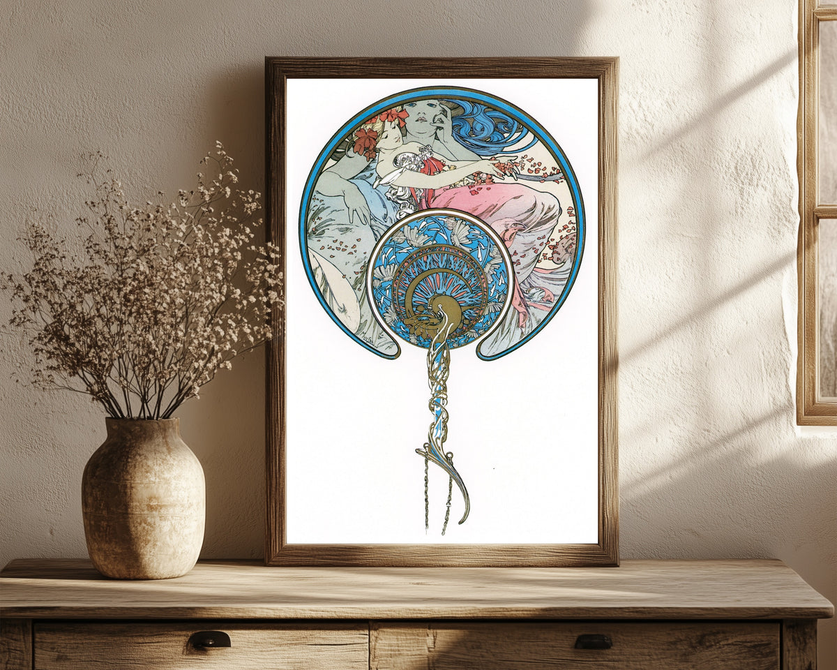 Framed art print of The Passing Wind Takes Youth Away by Alphonse Mucha, in a dark wood frame leaning on a rustic console beside dried flowers