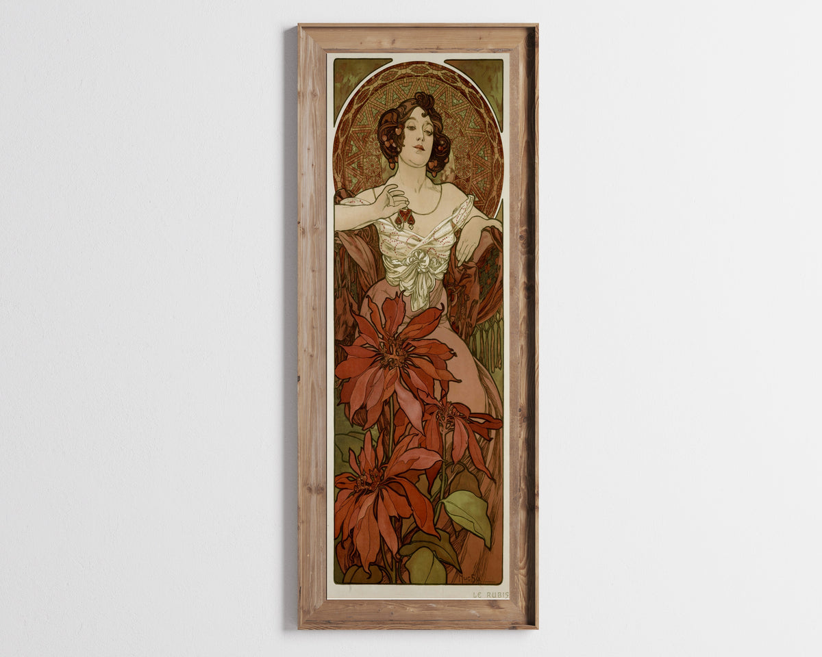 Framed art print of The Ruby by Alphonse Mucha, in a tall wooden frame on a pale wall