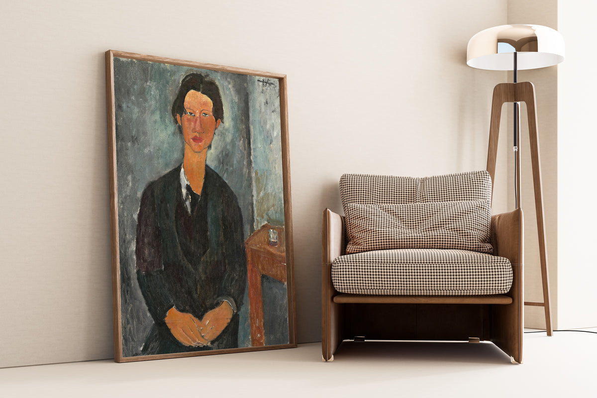 Chaim Soutine by Amedeo Modigliani — framed and leaning against a wall beside an armchair and a floor lamp