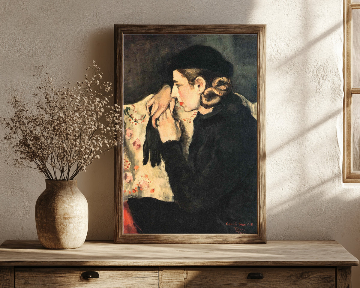 Framed art print of Denise Prouteaux (1932) by Amrita Sher-Gil, in a dark wood frame leaning on a rustic console beside dried flowers