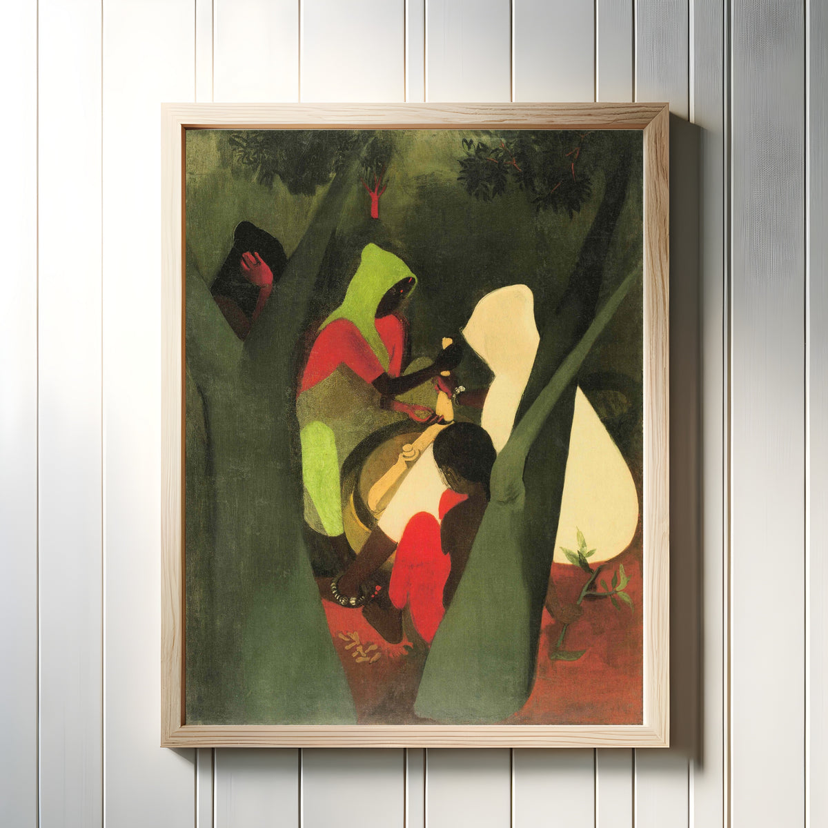 Framed art print of Haldi Grinders (1940) by Amrita Sher-Gil, in a light wood frame on a white panelled wall