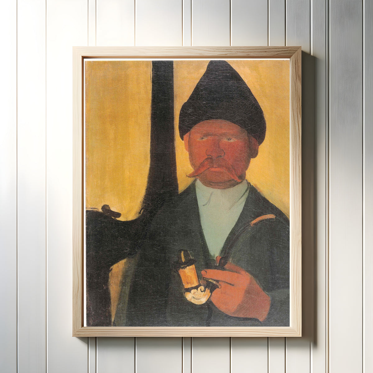Framed art print of Hungarian Peasant (1938) by Amrita Sher-Gil, in a light wood frame on a white panelled wall