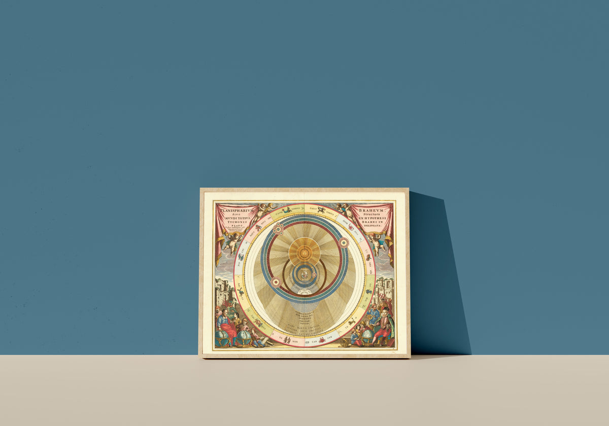 Framed art print of The Tychonic Planisphere (Plate 6, Rose Colouring) by Andreas Cellarius, in a light wood frame leaning on a blue wall