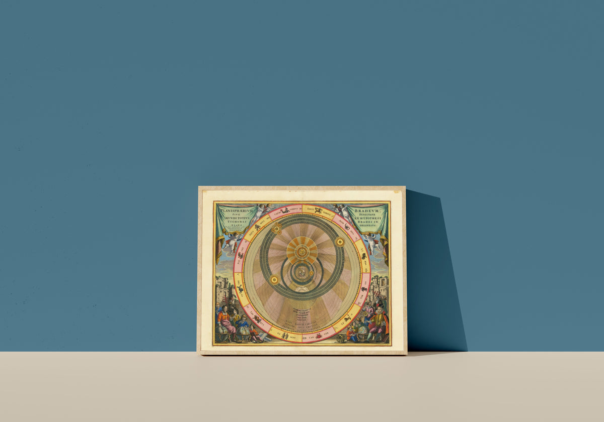 Framed art print of The Tychonic Planisphere (Plate 6, Teal Colouring) by Andreas Cellarius, in a light wood frame leaning on a blue wall