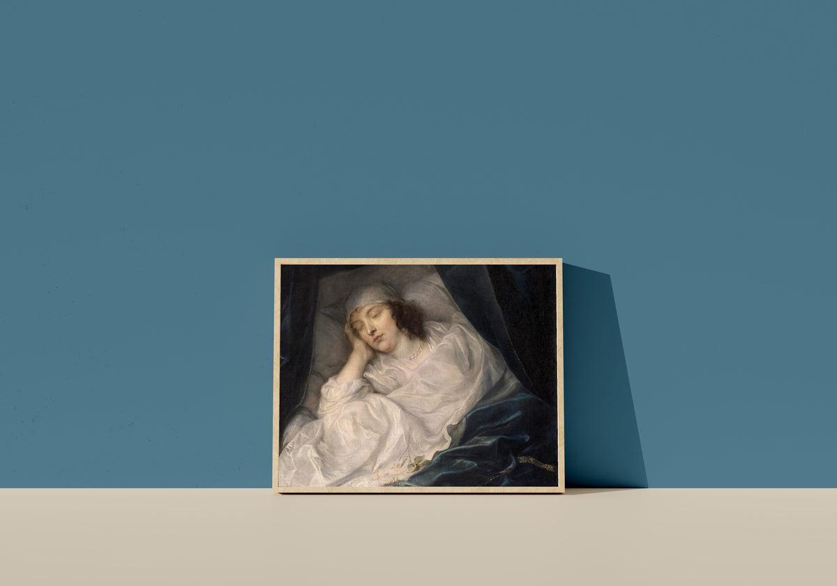 Framed art print of Venetia, Lady Digby, on Her Deathbed by Anthony van Dyck, in a light wood frame leaning on a blue wall