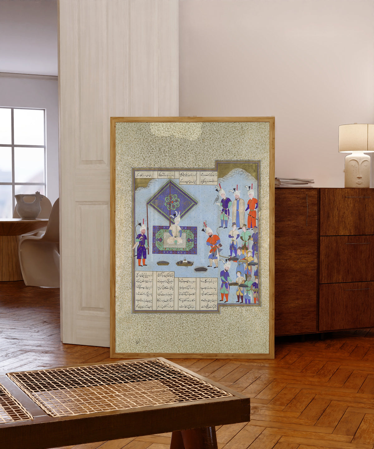 Framed art print of Shahnama of Shah Tahmasp: Kai Khusrau's War… by Aqa Mirak (attributed), in a light wood frame leaning in a warm room with a parquet floor