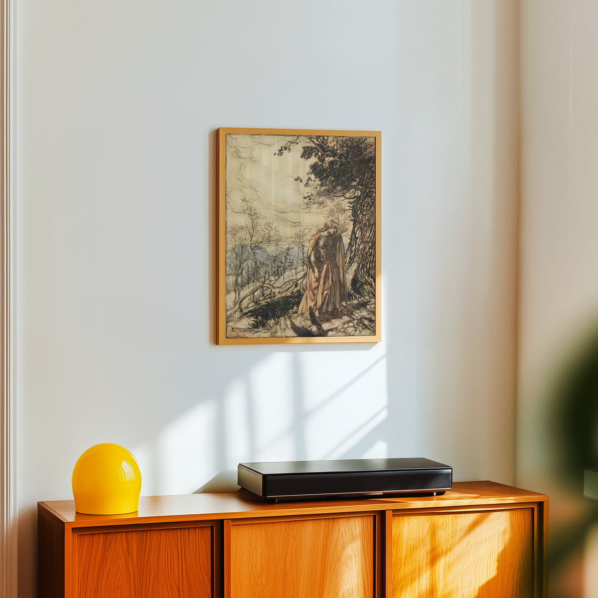 Framed art print of Brünnhilde Stands for a Long Time Dazed and Alarmed by Arthur Rackham, in a light wood frame on a white wall above an orange sideboard