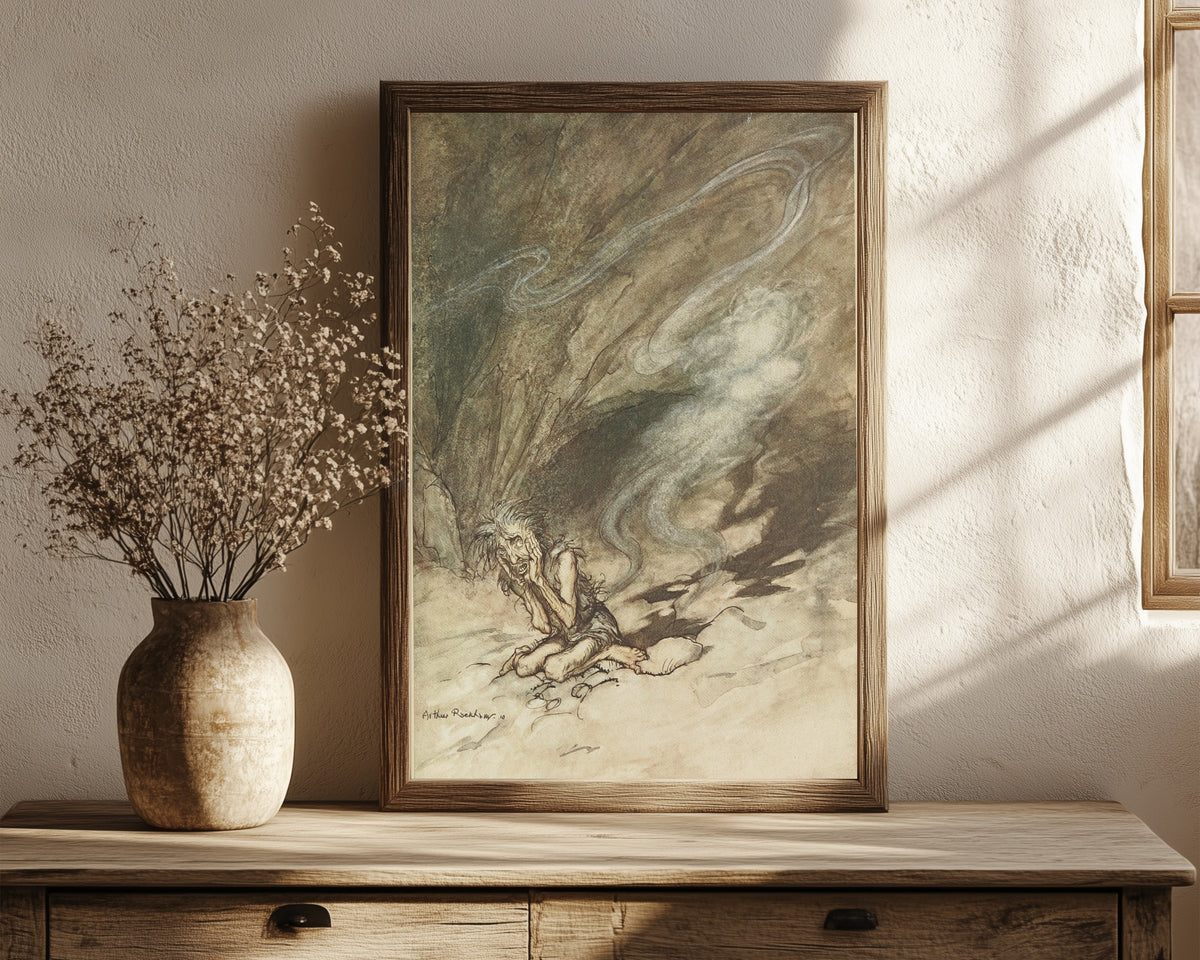Framed art print of Mime Writhes Under the Lashes He Receives by Arthur Rackham, in a dark wood frame leaning on a rustic console beside dried flowers