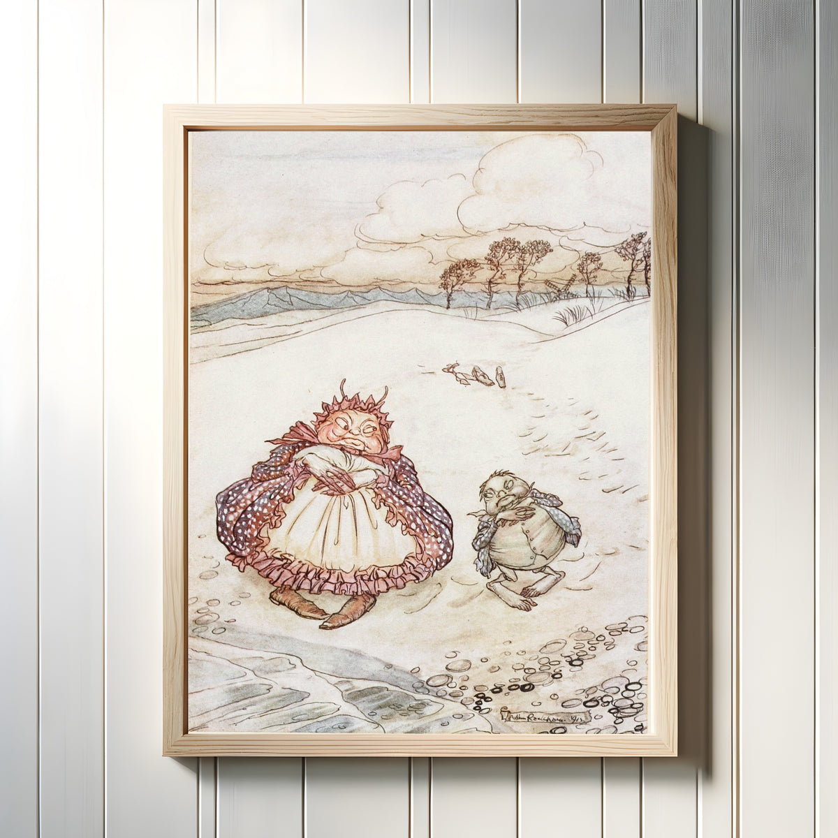Framed art print of The Crab and His Mother by Arthur Rackham, in a light wood frame on a white panelled wall