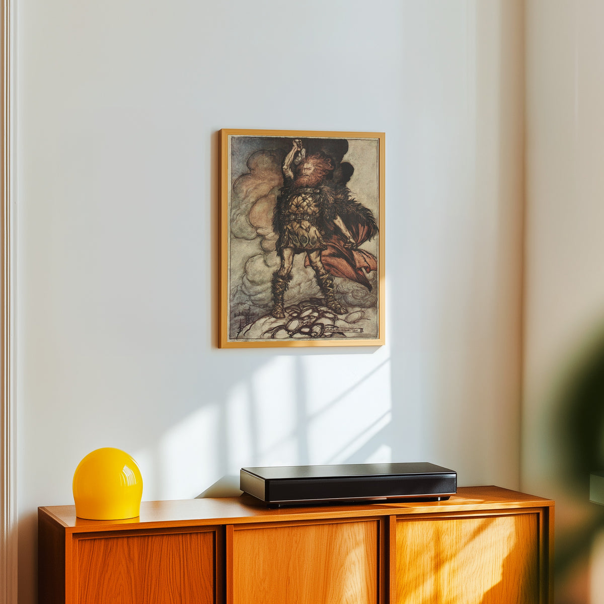 Framed art print of To My Hammer's Swing Hitherward Sweep Vapours and Fogs by Arthur Rackham, in a light wood frame on a white wall above an orange sideboard