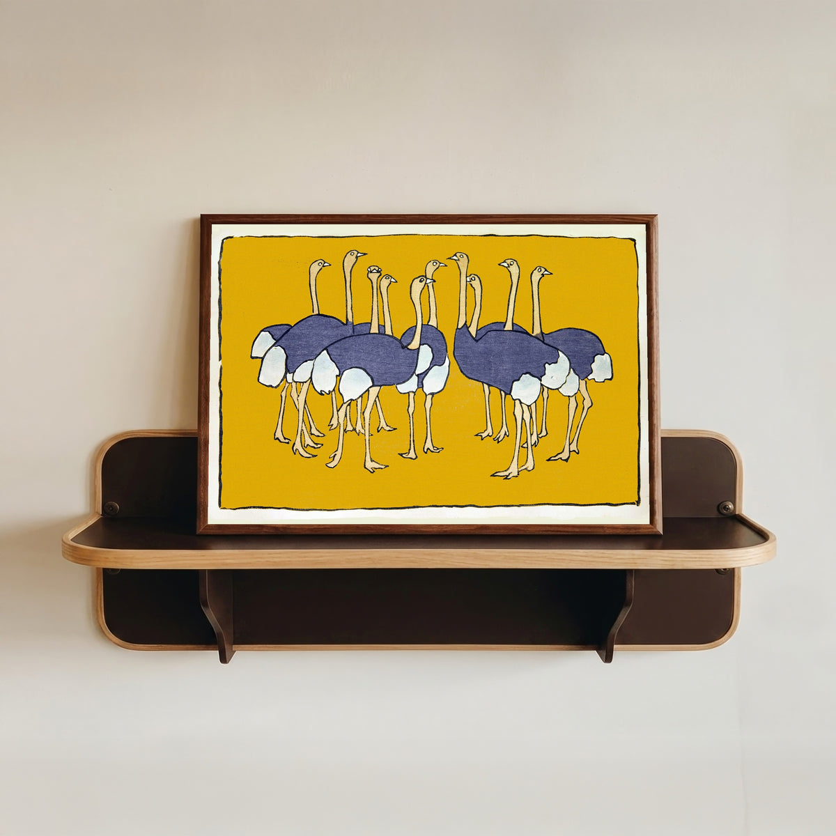 Framed art print of Ostriches by Asai Chū, in a dark wood frame resting on a wall shelf