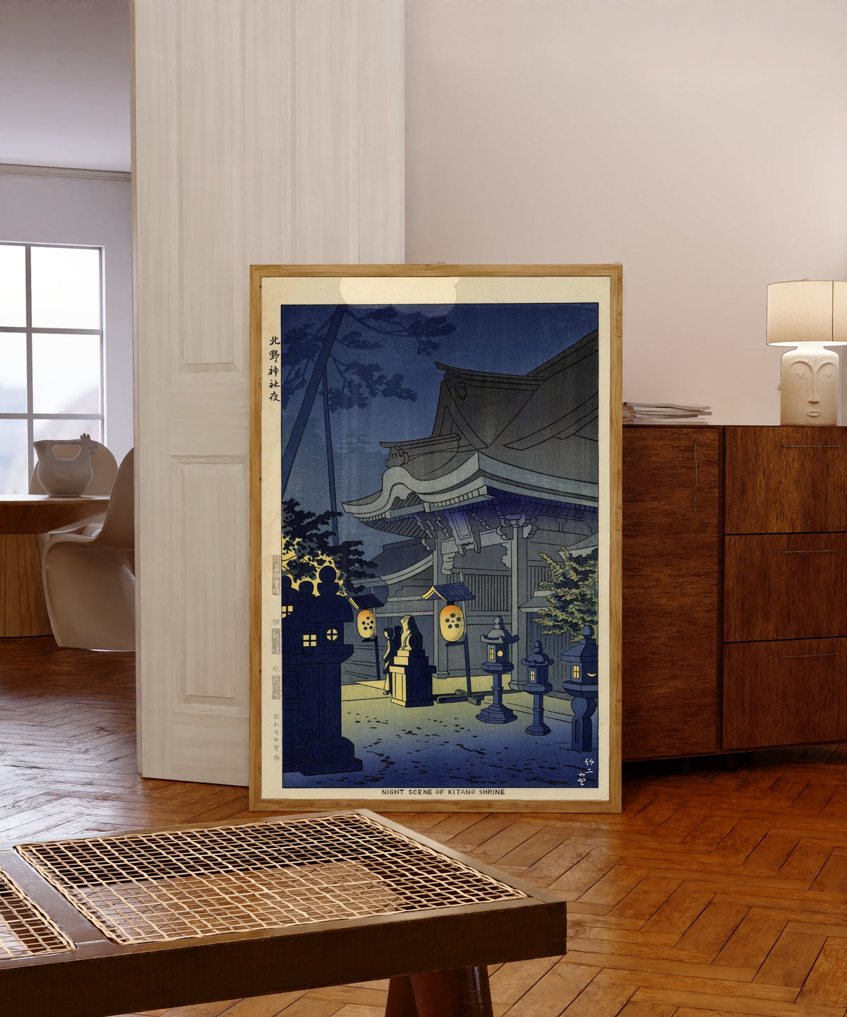 Framed art print of Night Scene of Kitano Shrine by Asano Takeji, in a light wood frame leaning in a warm room with a parquet floor