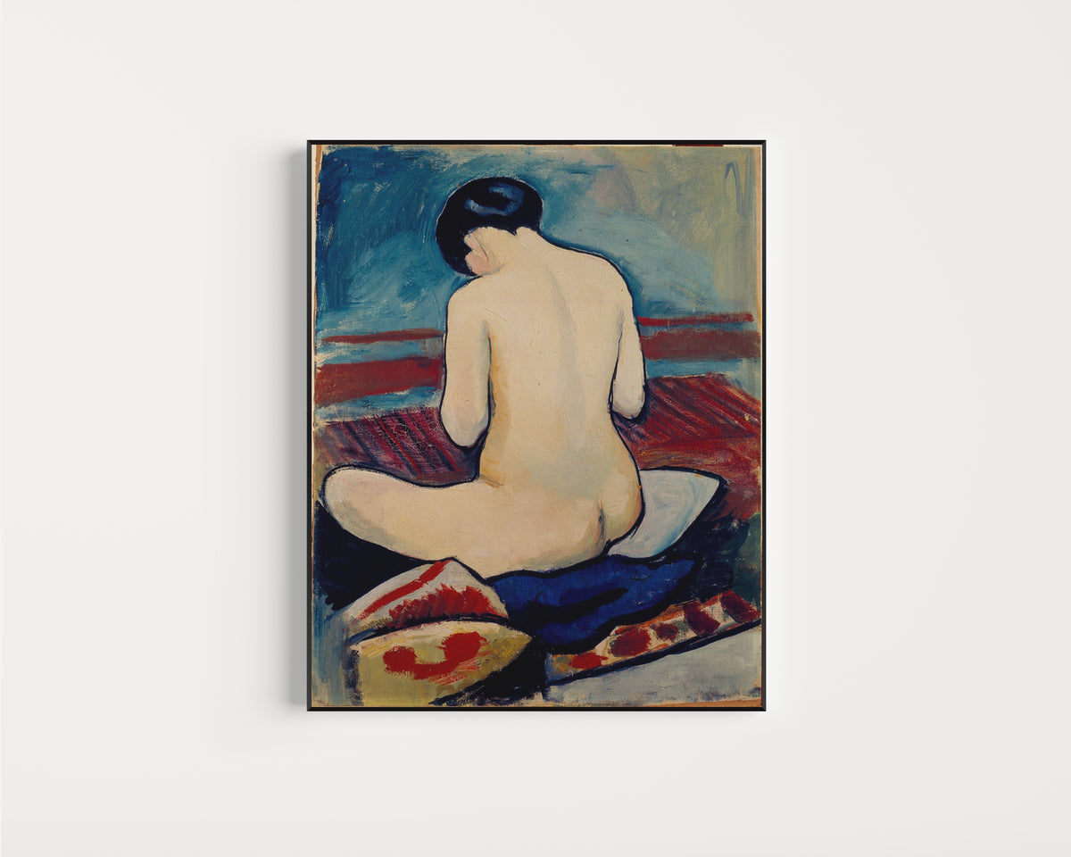 Framed art print of Sitting Nude with Pillow by August Macke, in a slim black frame on a plain white wall
