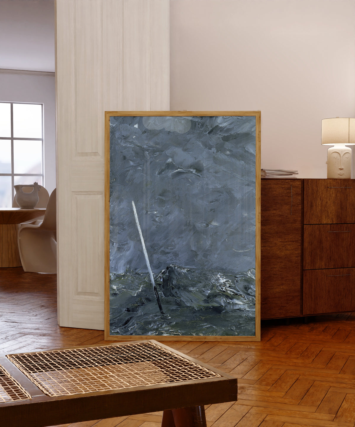 Framed art print of Stormy Sea, Buoy without Top Mark by August Strindberg, in a light wood frame leaning in a warm room with a parquet floor