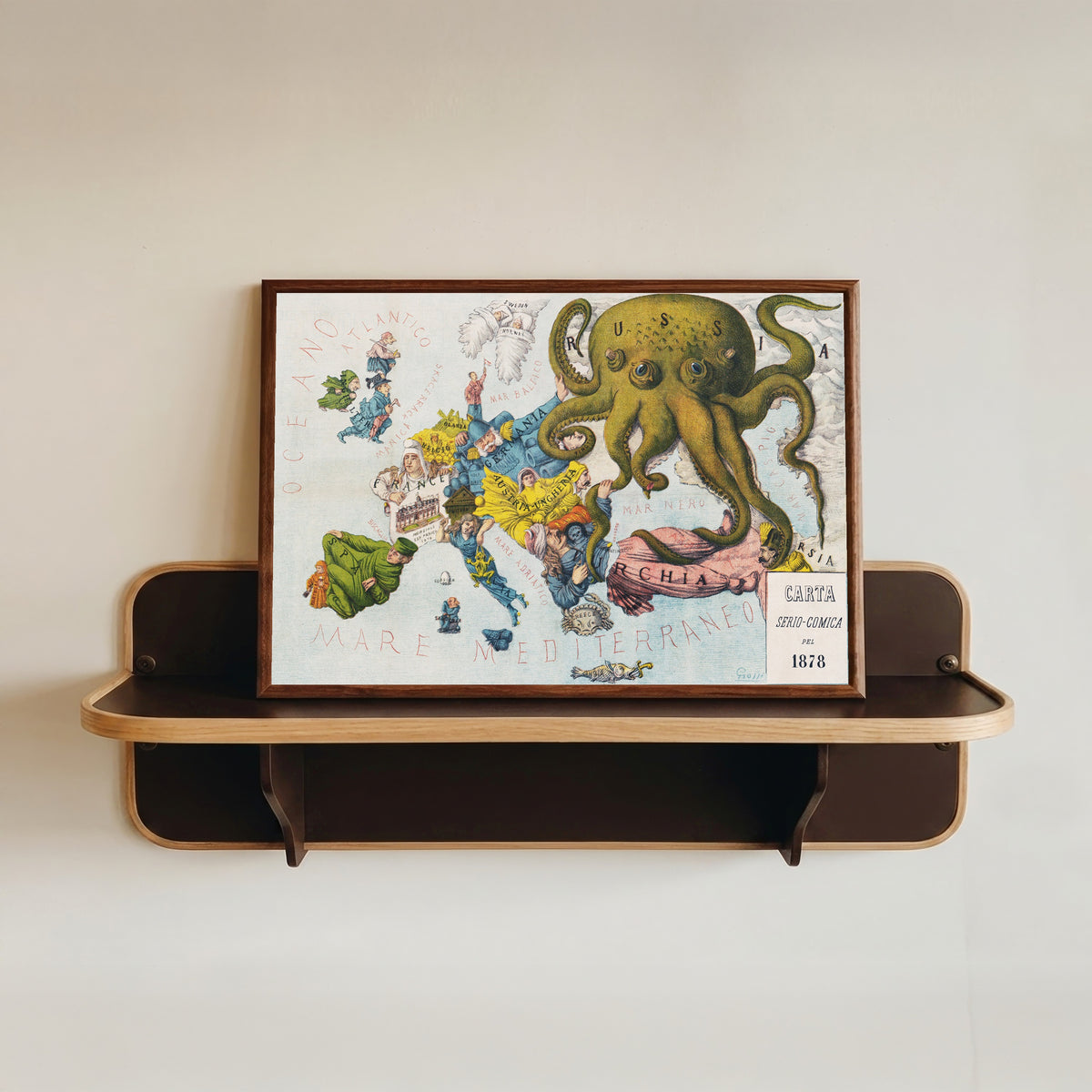 Framed art print of La Piovra Russa: Carta Serio-Comica 1878 by Augusto Grossi, in a dark wood frame resting on a wall shelf
