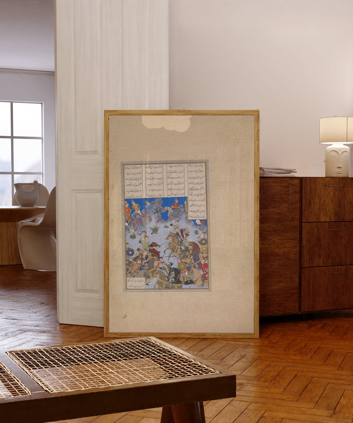 Framed art print of Shahnama of Shah Tahmasp: Khusrau Parviz's… by Bashdan Qara (attributed), in a light wood frame leaning in a warm room with a parquet floor