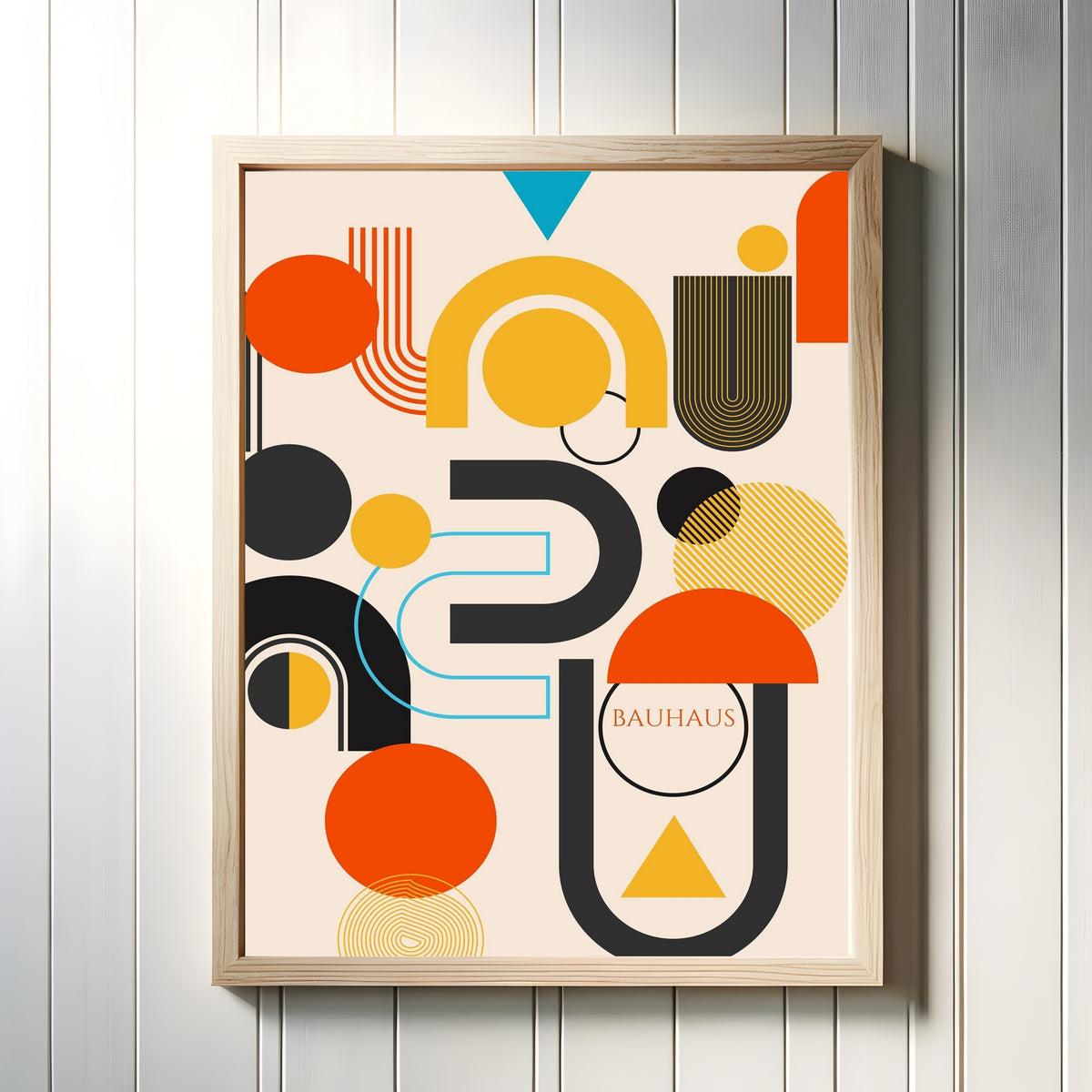 Framed art print of Big Bang by Bauhaus, in a light wood frame on a white panelled wall