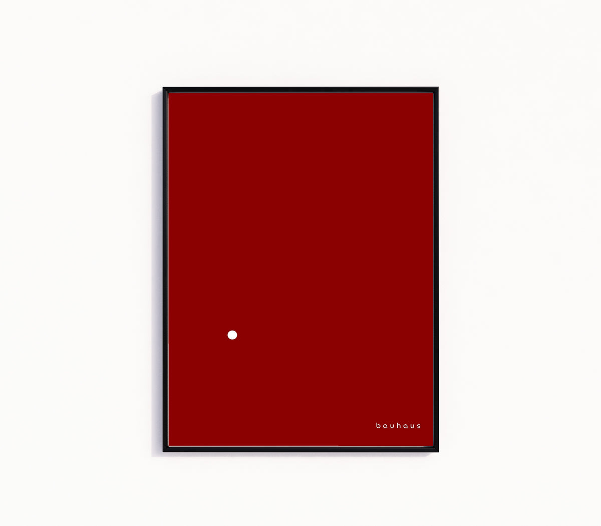 Framed art print of Bauhaus Der Punkt (The Dot) by Bauhaus, in a slim black frame on a plain white wall