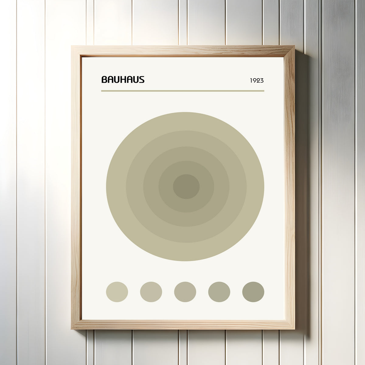 Framed art print of The Target by Bauhaus, in a light wood frame on a white panelled wall