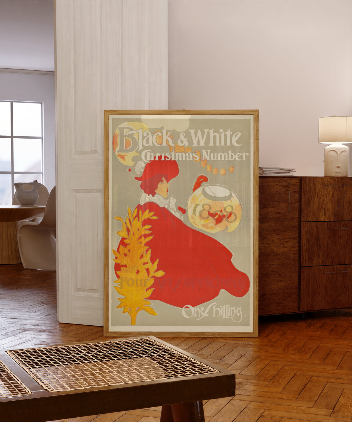Framed art print of Black & White, Christmas Number 1898, in a light wood frame leaning in a warm room with a parquet floor