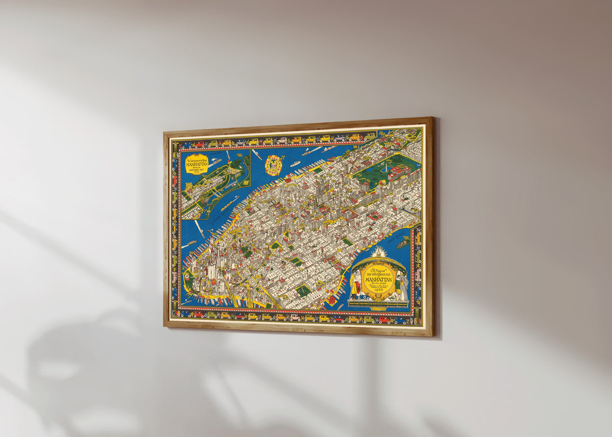 Framed art print of A Map of the Wondrous Isle of Manhattan by C. V. Farrow, in a light wood frame on a sunlit white wall, seen at a slight angle