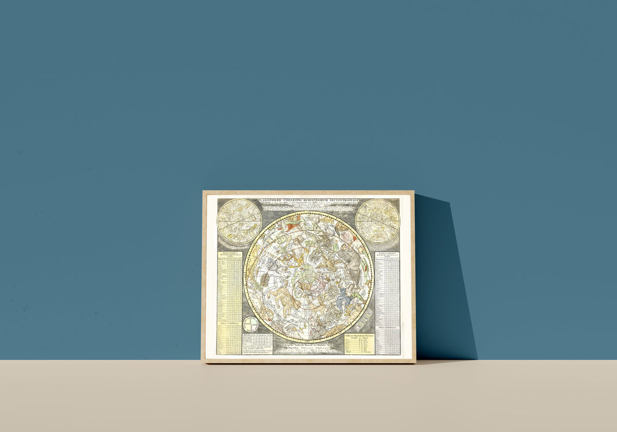 Framed art print of Planisphaerii Coelestis Hemisphaerium Septentrionale by Carel Allard, in a light wood frame leaning on a blue wall