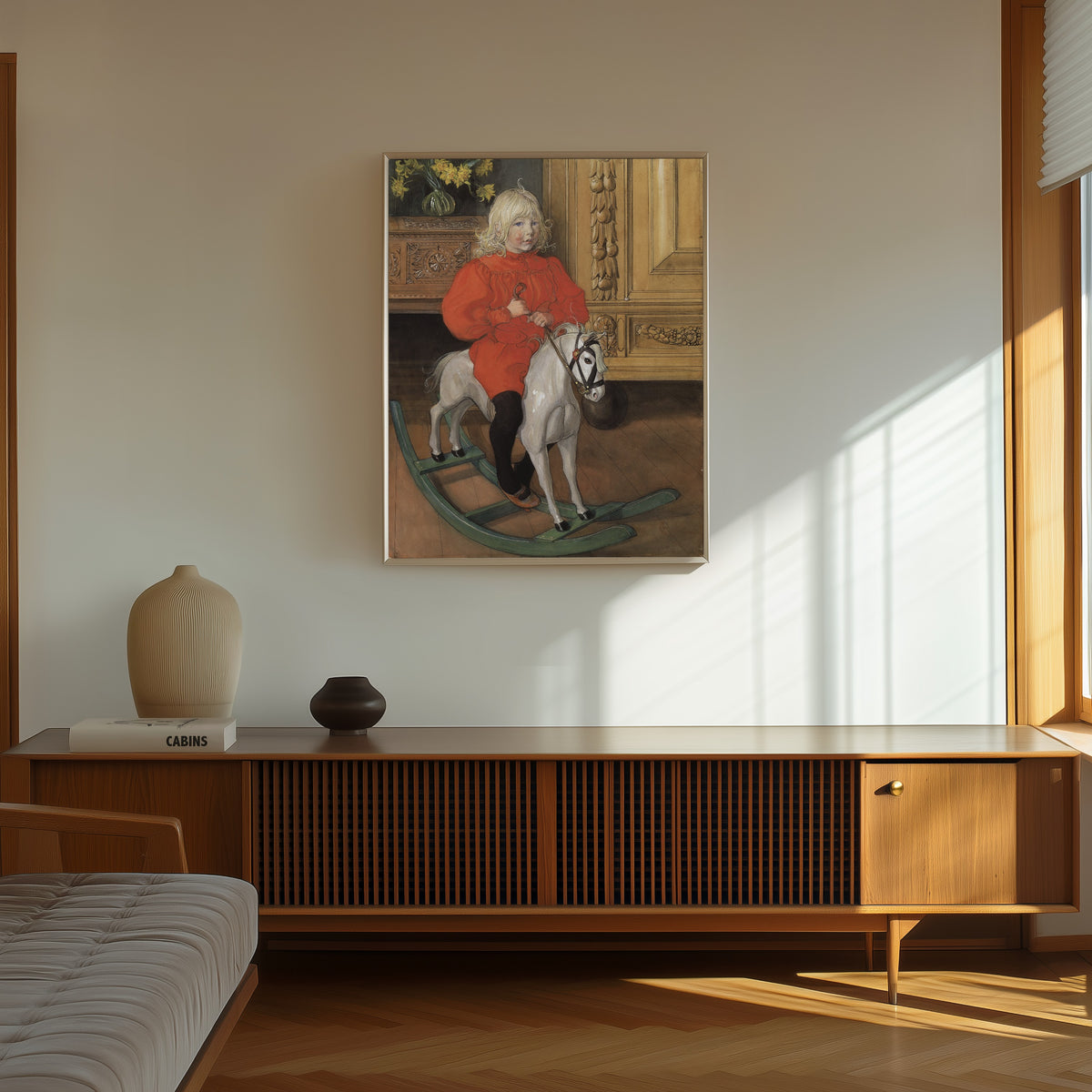 Framed art print of Murre: Portrait of Casimir Laurin by Carl Larsson, in a thin light frame on a sunlit wall above a wooden sideboard