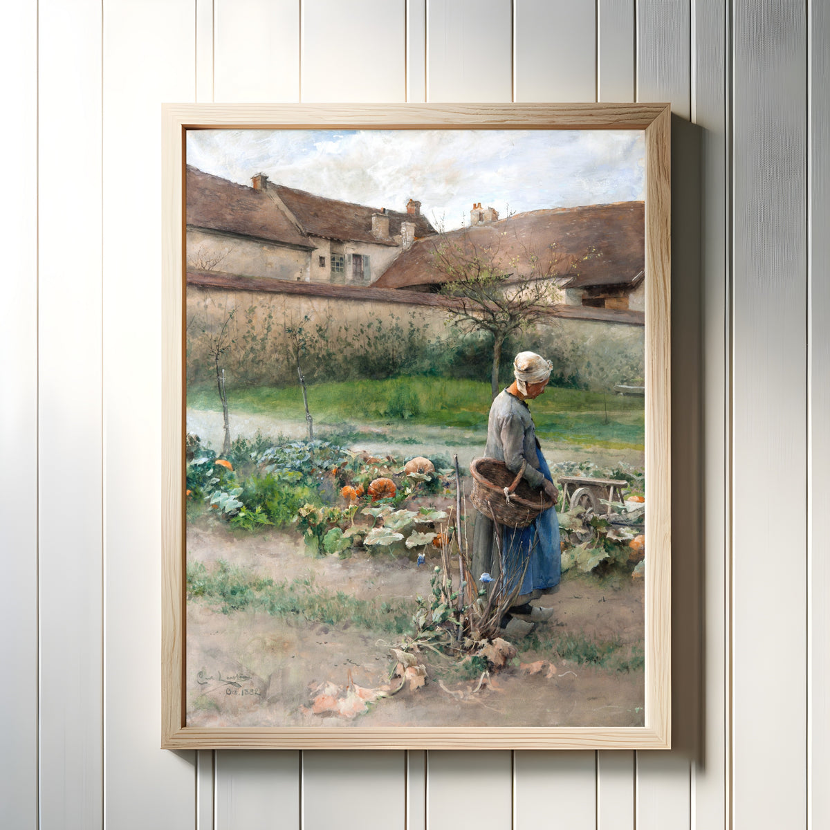 Framed art print of October by Carl Larsson, in a light wood frame on a white panelled wall