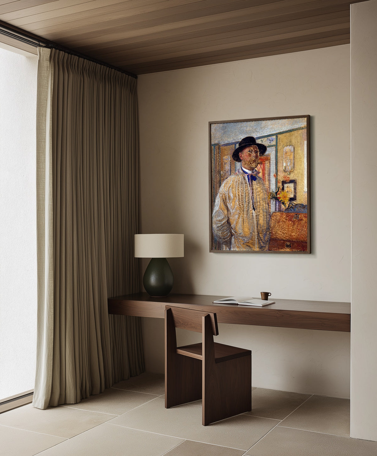 Framed art print of Self-Portrait by Carl Larsson, in a dark wood frame on a plaster wall above a walnut desk