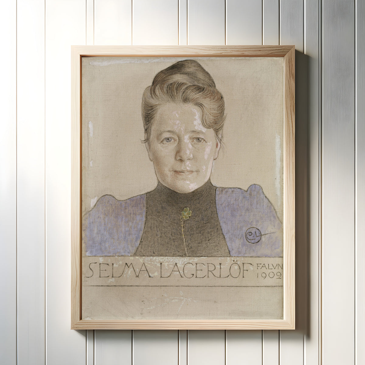 Framed art print of The Author Selma Lagerlöf by Carl Larsson, in a light wood frame on a white panelled wall