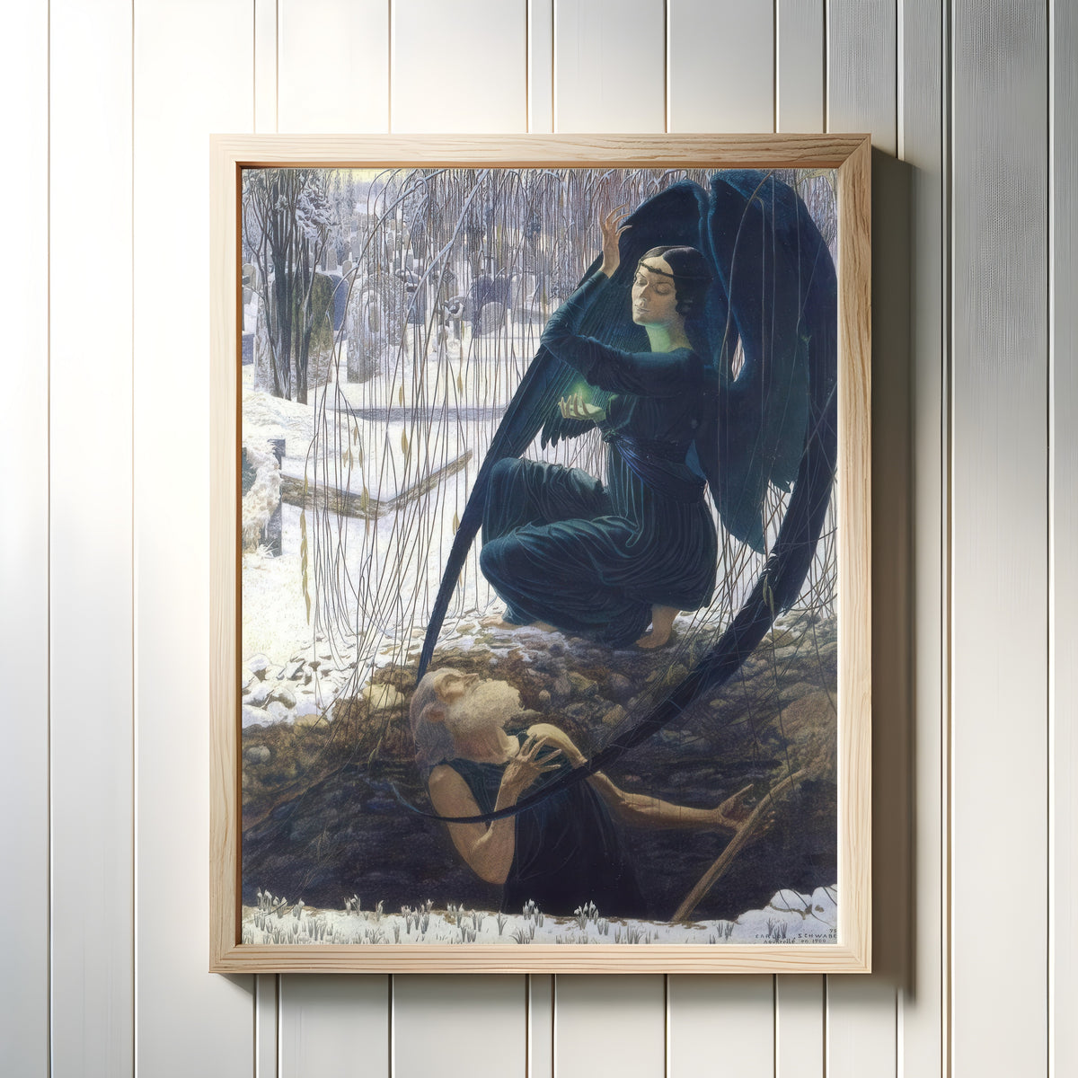 Framed art print of Death and the Gravedigger by Carlos Schwabe, in a light wood frame on a white panelled wall