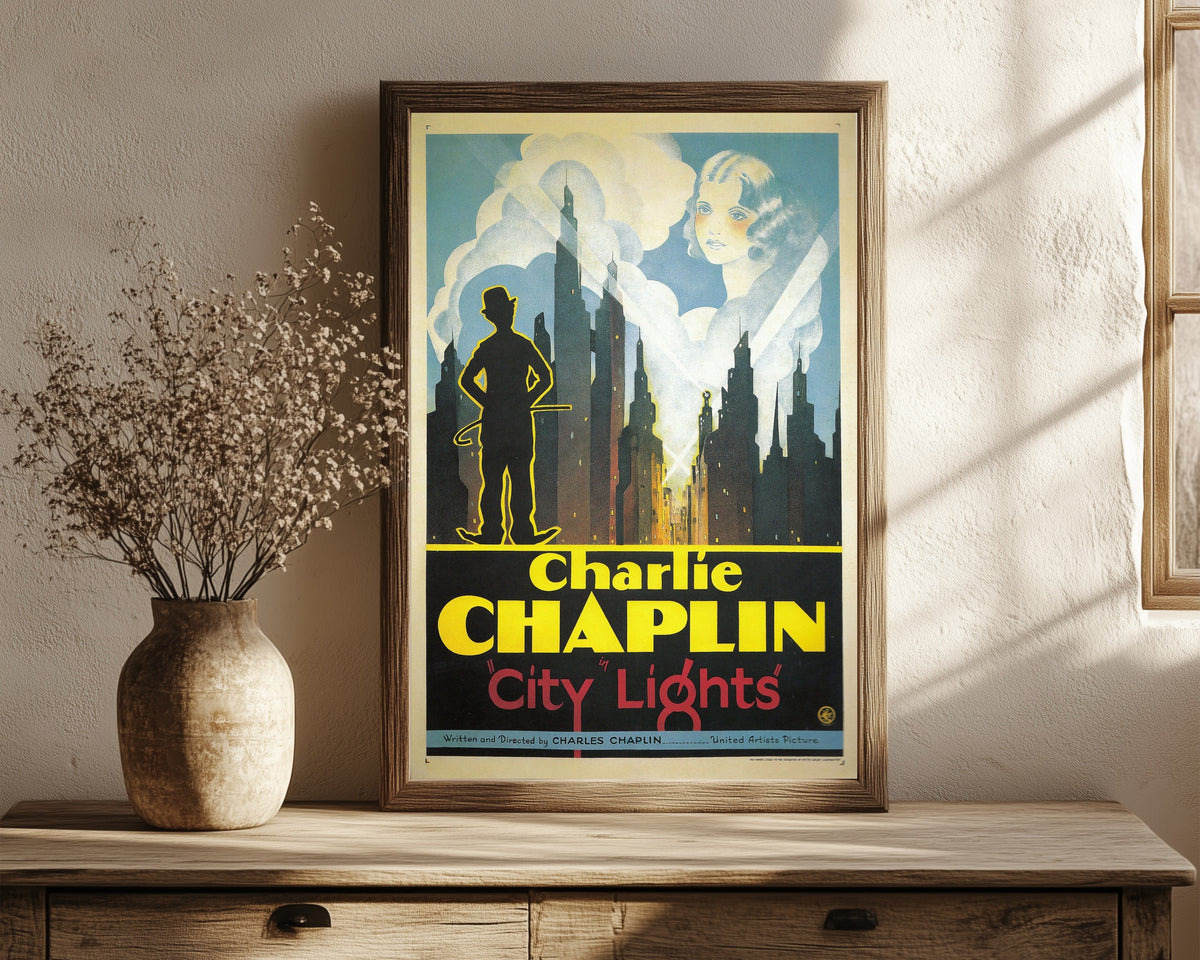 Framed art print of City Lights, in a dark wood frame leaning on a rustic console beside dried flowers