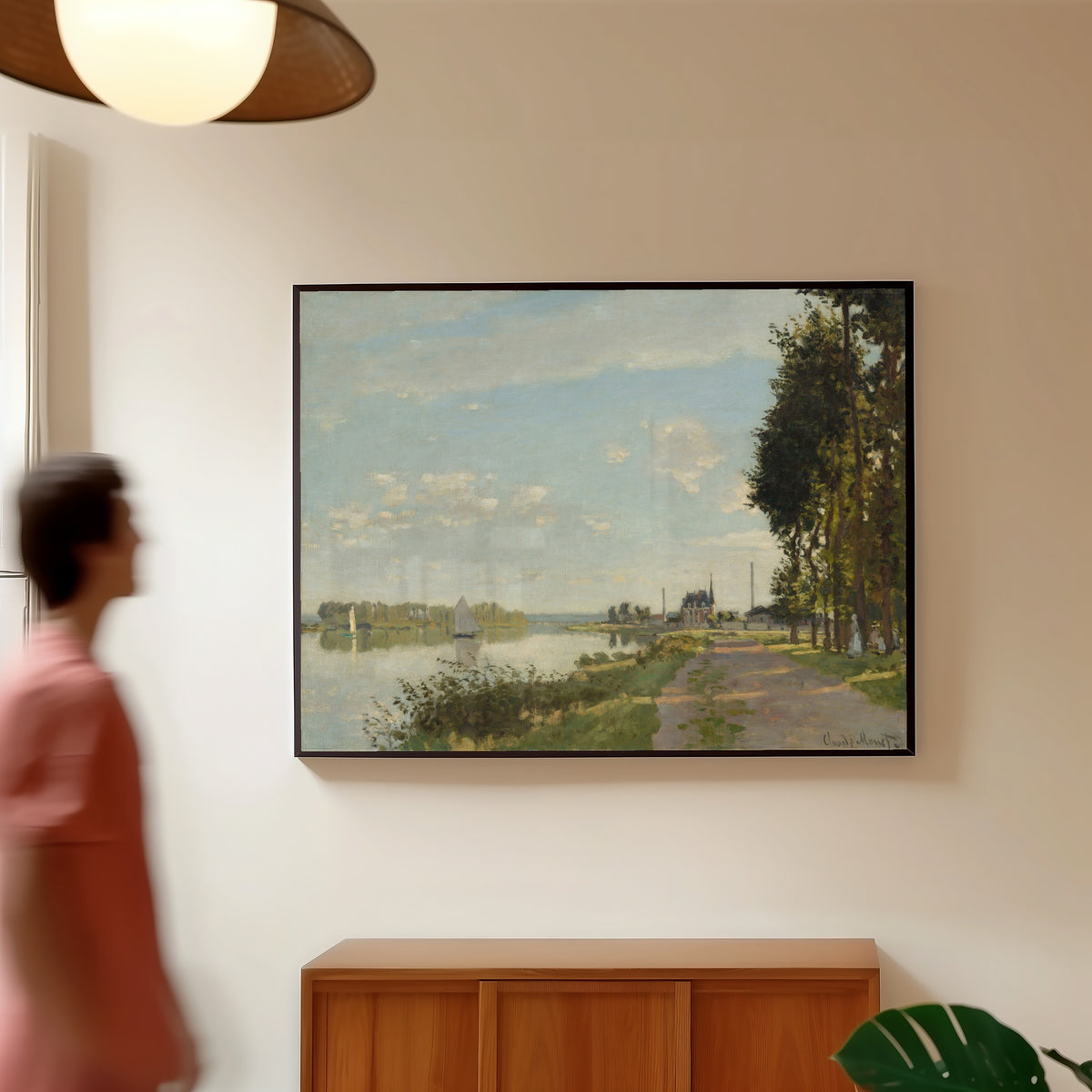 Framed art print of Argenteuil by Claude Monet, in a slim black frame on a warm wall in a sunlit room