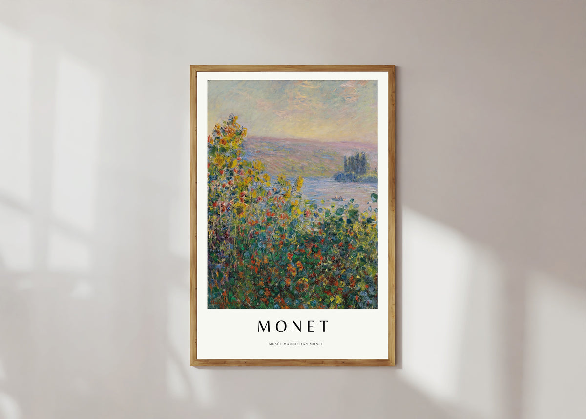 Framed art print of Flower Beds by Claude Monet, in a light wood frame on a sunlit white wall